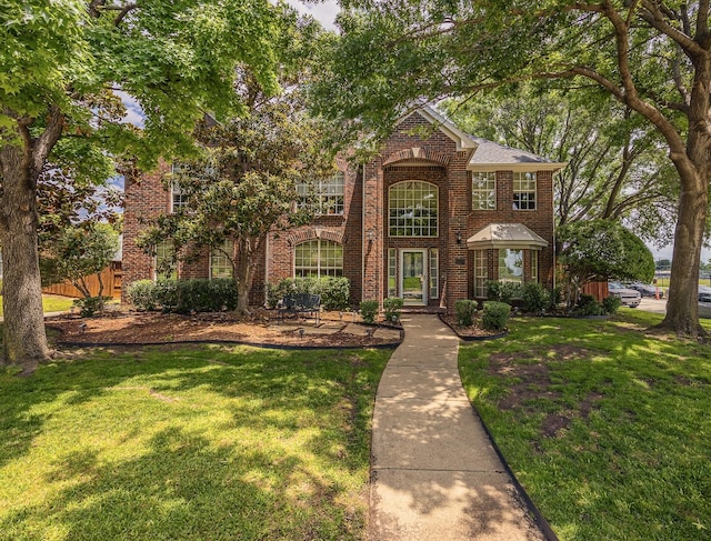 6720 Grant Ln, Plano, TX 75024 - view of front facade featuring brick siding and a front lawn