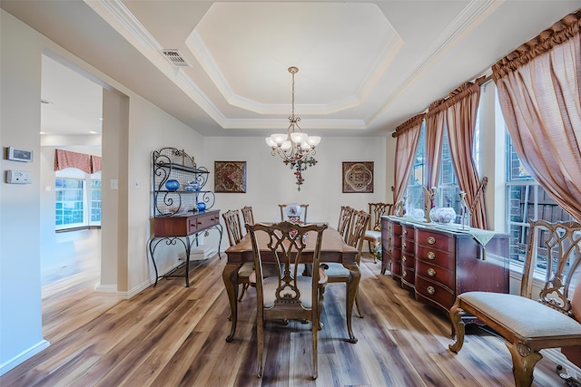 6720 Grant Ln, Plano, TX 75024 - dining space featuring a chandelier, wood finished floors, ornamental molding, a raised ceiling, and baseboards