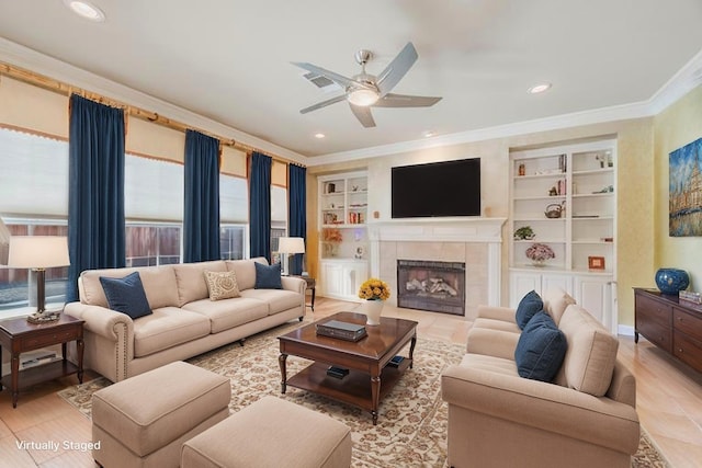 6720 Grant Ln, Plano, TX 75024 - living room with ornamental molding, a ceiling fan, light wood-style flooring, a tiled fireplace, and built in shelves