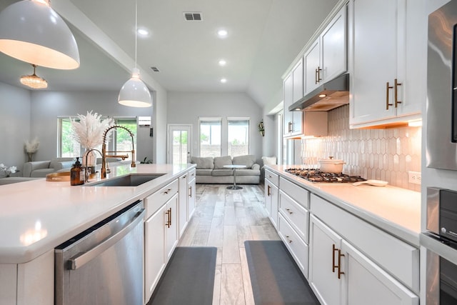 1733 Ann St, Celina, TX 75009 - kitchen with appliances with stainless steel finishes, under cabinet range hood, open floor plan, a sink, and recessed lighting