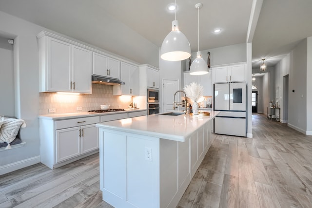1733 Ann St, Celina, TX 75009 - kitchen with a sink, under cabinet range hood, appliances with stainless steel finishes, white cabinetry, and light wood-style flooring
