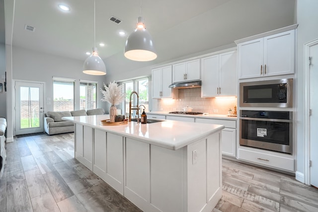 1733 Ann St, Celina, TX 75009 - kitchen featuring stainless steel oven, built in microwave, a sink, light countertops, and tasteful backsplash