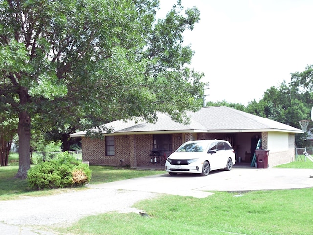 401 E Hunt St, Leonard, TX 75452 - view of side of property featuring driveway, a lawn, and brick siding