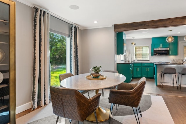 5308 Parkland Ave, Dallas, TX 75235 - dining space featuring healthy amount of natural light, ornamental molding, recessed lighting, dark wood finished floors, and baseboards