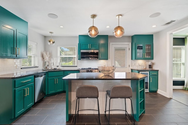 5308 Parkland Ave, Dallas, TX 75235 - kitchen with appliances with stainless steel finishes, a sink, beverage cooler, a kitchen breakfast bar, and decorative backsplash