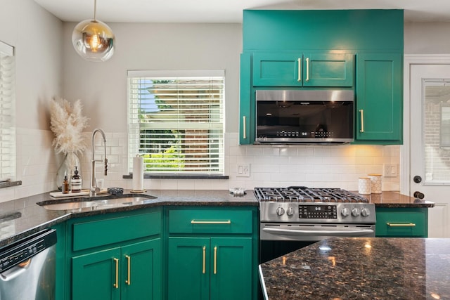 5308 Parkland Ave, Dallas, TX 75235 - kitchen with stainless steel appliances, a sink, tasteful backsplash, and dark stone countertops