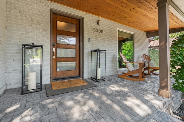 5308 Parkland Ave, Dallas, TX 75235 - view of exterior entry with brick siding and a porch