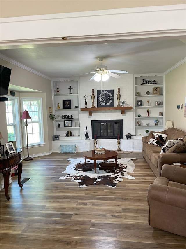 2620 County Road 1102, Grandview, TX 76050 - living area with built in features, ornamental molding, wood finished floors, ceiling fan, and a brick fireplace