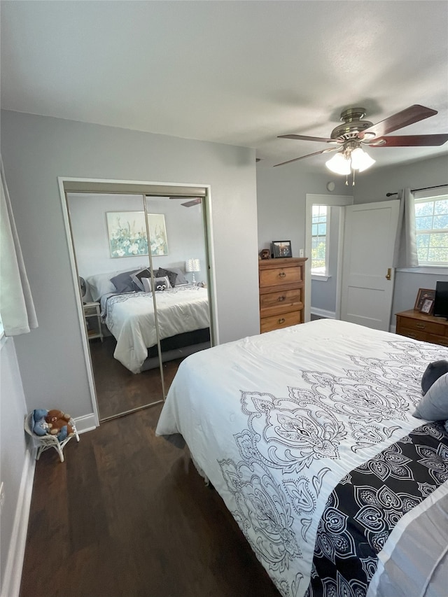 2620 County Road 1102, Grandview, TX 76050 - bedroom with dark wood-style floors, a closet, a ceiling fan, and baseboards