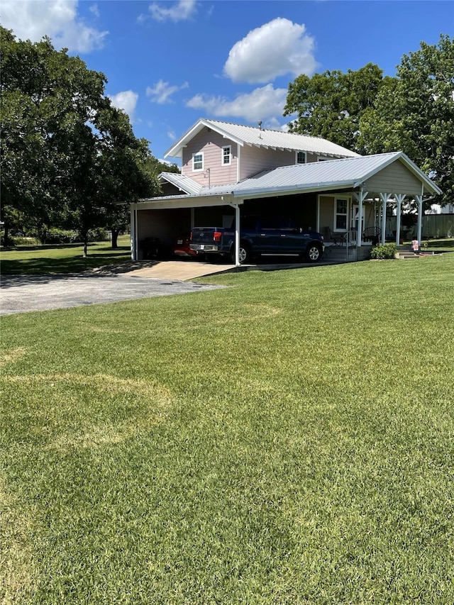 2620 County Road 1102, Grandview, TX 76050 - view of side of property featuring driveway, a carport, a lawn, and metal roof