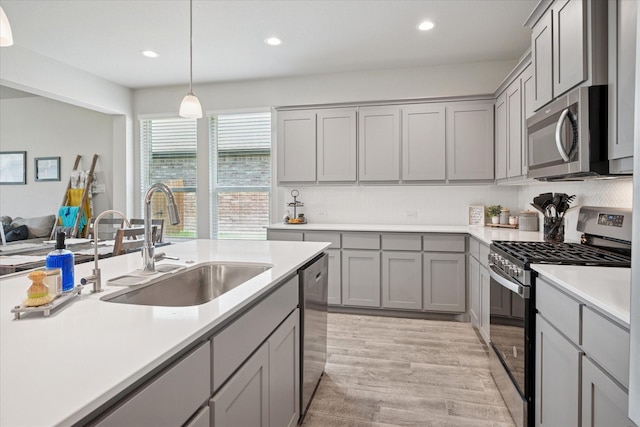 5213 Meadow Ln, Krum, TX 76249 - kitchen featuring appliances with stainless steel finishes, gray cabinetry, a sink, light countertops, and recessed lighting