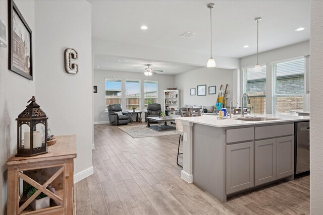 5213 Meadow Ln, Krum, TX 76249 - kitchen with a sink, gray cabinets, stainless steel dishwasher, light wood finished floors, and recessed lighting
