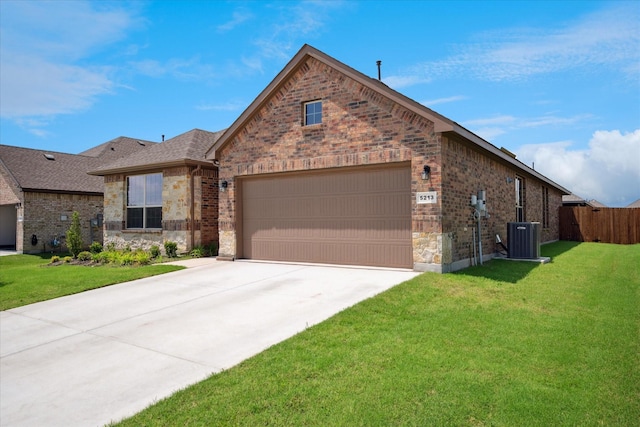 5213 Meadow Ln, Krum, TX 76249 - view of front of house featuring an attached garage, brick siding, driveway, central AC unit, and stone siding