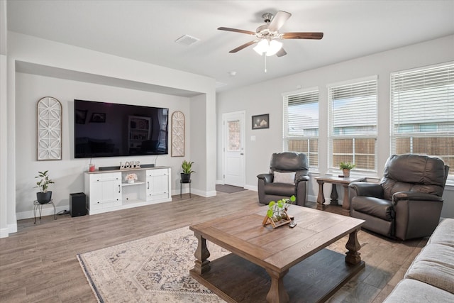 5213 Meadow Ln, Krum, TX 76249 - living room featuring light wood-style flooring, a ceiling fan, and baseboards