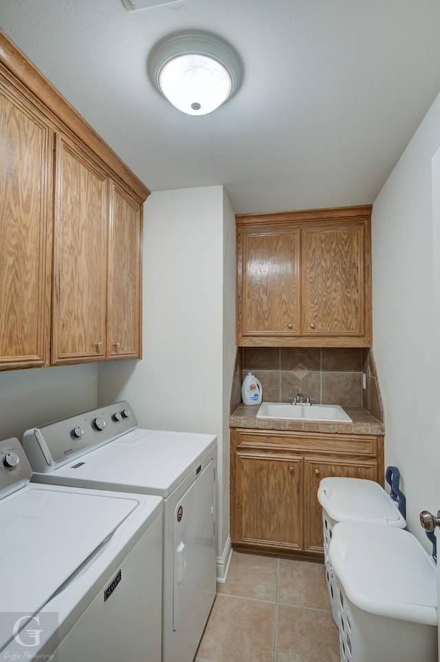 4002 Wilderness Ln, Bossier City, LA 71111 - laundry room with washer and clothes dryer, cabinet space, and light tile patterned flooring
