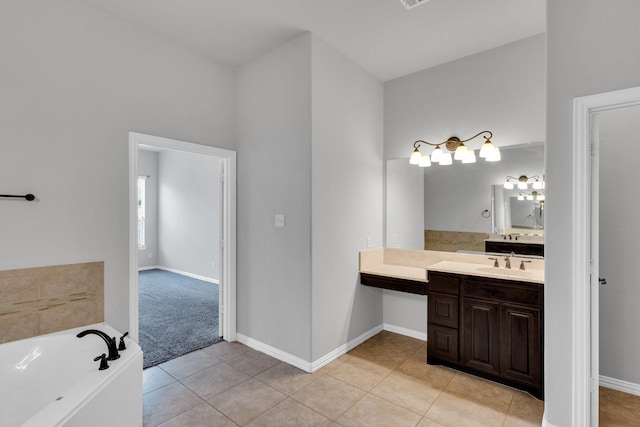 417 Sagebrush Ln, Waxahachie, TX 75165 - bathroom with a tub, vanity, tile patterned floors, and baseboards