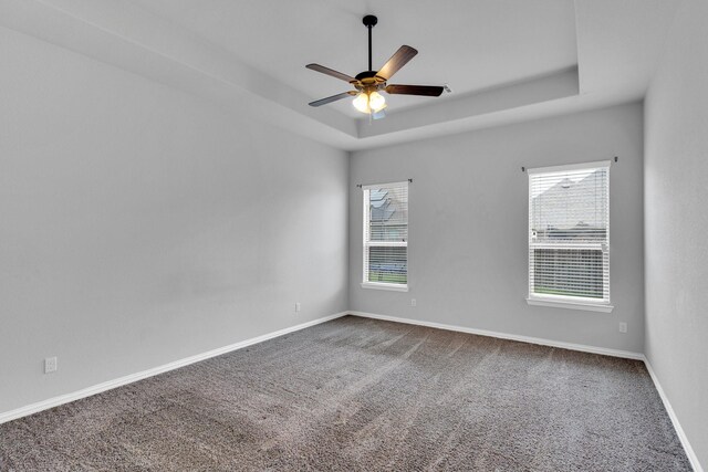 417 Sagebrush Ln, Waxahachie, TX 75165 - unfurnished room featuring a tray ceiling, carpet floors, a ceiling fan, and baseboards