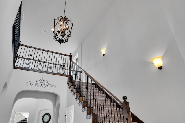 417 Sagebrush Ln, Waxahachie, TX 75165 - stairway with a towering ceiling, a chandelier, and arched walkways