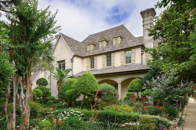 2900 Amherst Ave, University Park, TX 75225 - view of front facade featuring a high end roof, a chimney, stone siding, and a porch