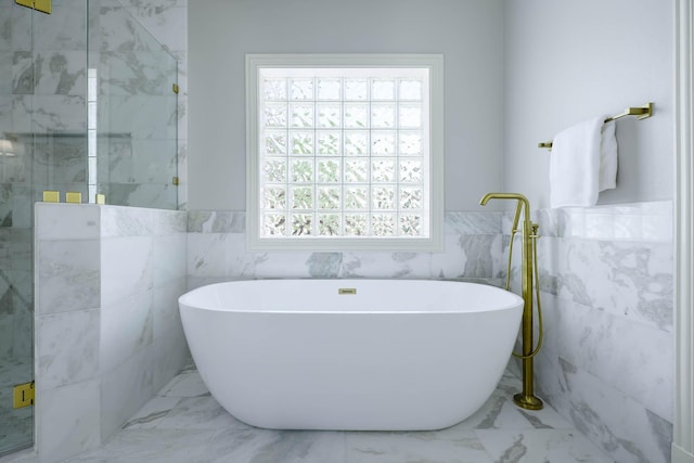 2900 Amherst Ave, University Park, TX 75225 - bathroom featuring tile walls, marble finish flooring, a freestanding bath, wainscoting, and walk in shower