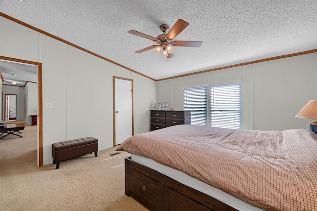 115 Candlewood Cir, Gainesville, TX 76240 - bedroom with ornamental molding, light carpet, a textured ceiling, vaulted ceiling, and ceiling fan