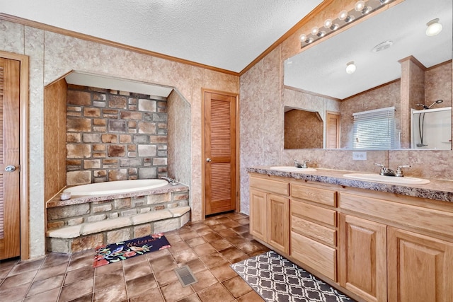115 Candlewood Cir, Gainesville, TX 76240 - bathroom featuring ornamental molding, a bath, vaulted ceiling, double vanity, and a textured ceiling