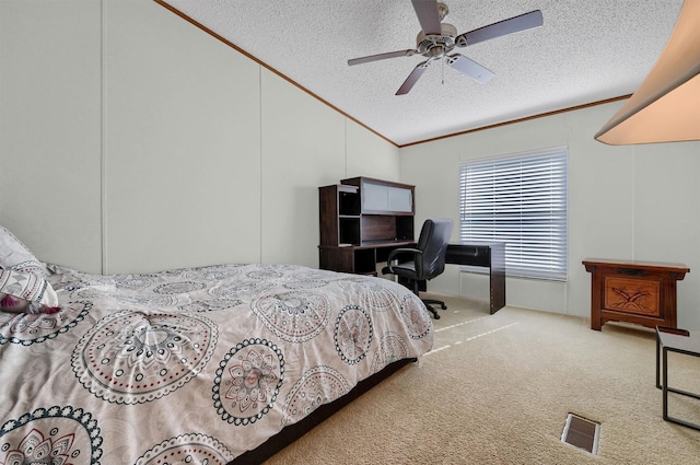 115 Candlewood Cir, Gainesville, TX 76240 - bedroom featuring lofted ceiling, crown molding, a textured ceiling, carpet floors, and ceiling fan