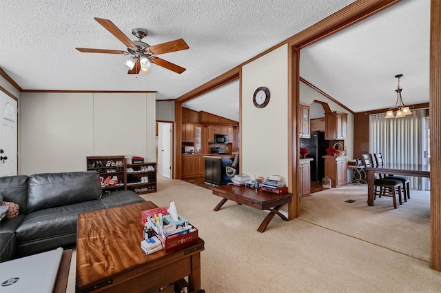 115 Candlewood Cir, Gainesville, TX 76240 - carpeted living area featuring crown molding, ceiling fan, vaulted ceiling, a textured ceiling, and a chandelier