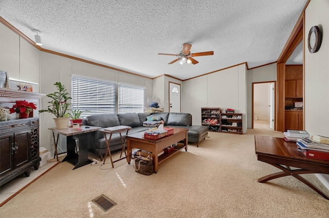 115 Candlewood Cir, Gainesville, TX 76240 - living area featuring ornamental molding, carpet flooring, ceiling fan, a textured ceiling, and a decorative wall