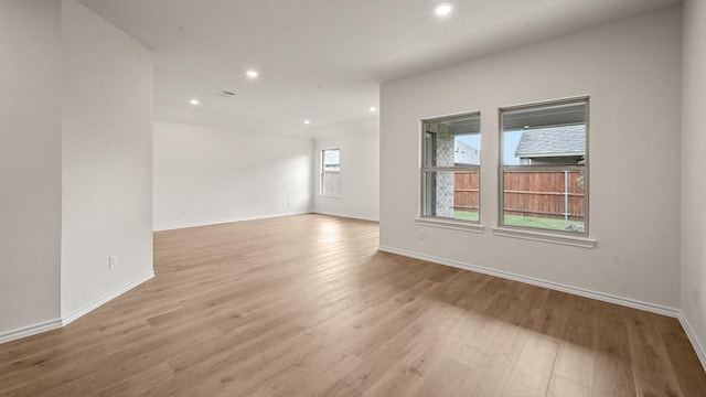 504 Drake Dr, Ferris, TX 75125 - spare room with light wood-style floors and recessed lighting