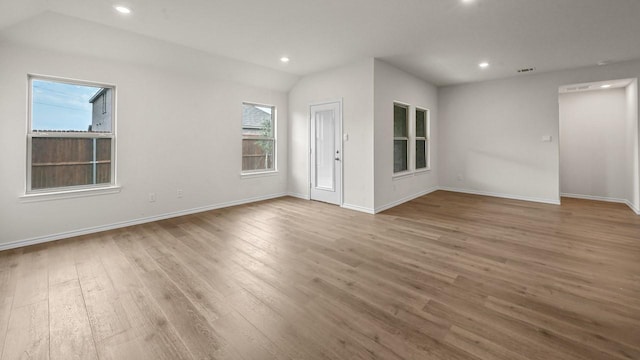504 Drake Dr, Ferris, TX 75125 - spare room featuring wood finished floors, recessed lighting, and vaulted ceiling