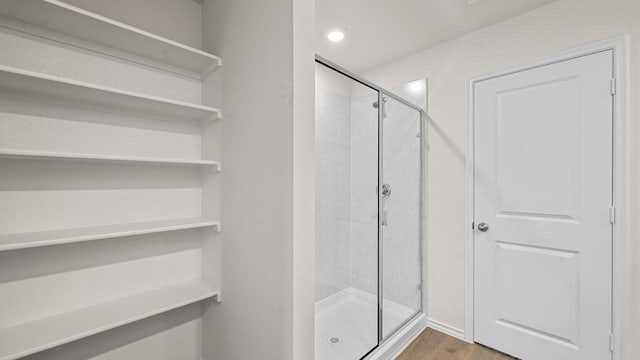 504 Drake Dr, Ferris, TX 75125 - bathroom featuring a shower stall and wood finished floors