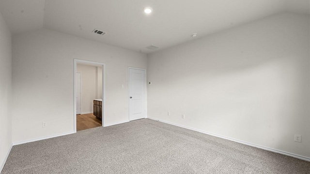 504 Drake Dr, Ferris, TX 75125 - unfurnished bedroom featuring carpet floors, lofted ceiling, connected bathroom, and recessed lighting