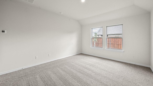 504 Drake Dr, Ferris, TX 75125 - carpeted empty room featuring vaulted ceiling and baseboards