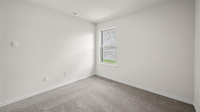 504 Drake Dr, Ferris, TX 75125 - empty room with carpet and a smoke detector