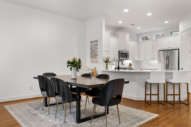 2408 Wild Cherry Way, Dallas, TX 75206 - dining room featuring ornamental molding, recessed lighting, light wood-type flooring, and baseboards