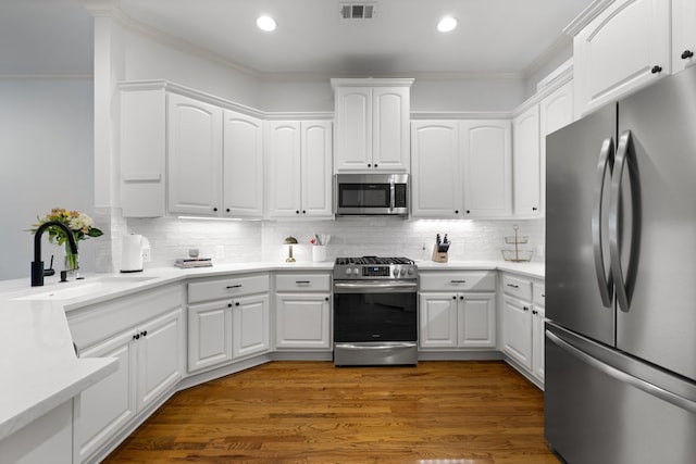 2408 Wild Cherry Way, Dallas, TX 75206 - kitchen with appliances with stainless steel finishes, a sink, ornamental molding, white cabinets, and recessed lighting