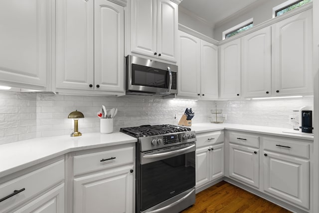2408 Wild Cherry Way, Dallas, TX 75206 - kitchen with stainless steel appliances, crown molding, white cabinets, tasteful backsplash, and dark wood finished floors
