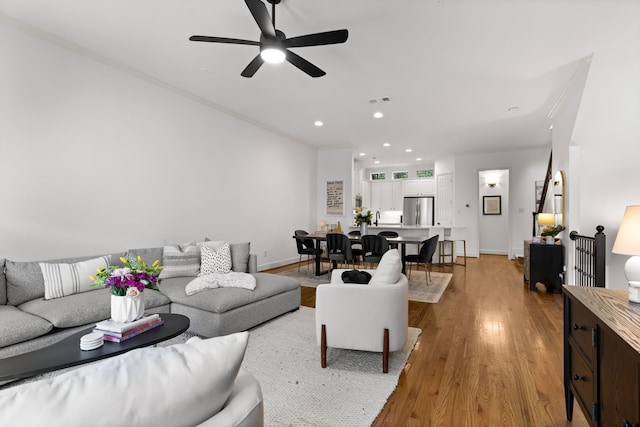 2408 Wild Cherry Way, Dallas, TX 75206 - living area featuring light wood finished floors, a ceiling fan, ornamental molding, recessed lighting, and baseboards