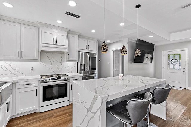 3039 Dutton Dr, Dallas, TX 75211 - kitchen with stainless steel appliances, light wood-style floors, backsplash, white cabinets, and recessed lighting