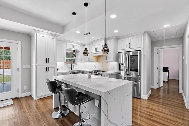 3039 Dutton Dr, Dallas, TX 75211 - kitchen with stainless steel appliances, baseboards, wood finished floors, light stone countertops, and recessed lighting