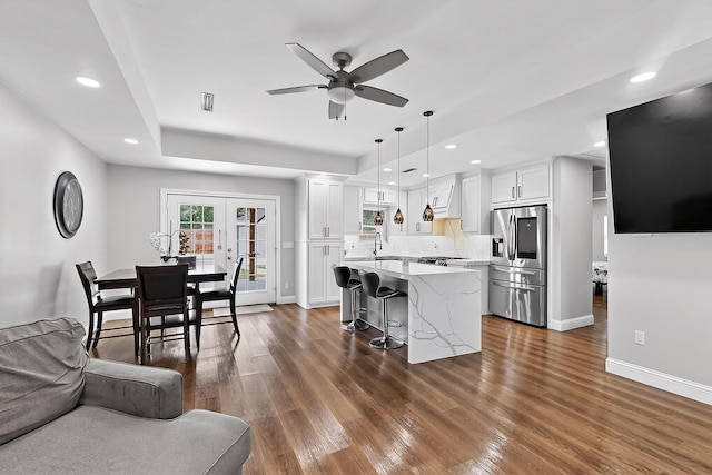 3039 Dutton Dr, Dallas, TX 75211 - kitchen featuring stainless steel fridge with ice dispenser, a kitchen breakfast bar, a ceiling fan, white cabinetry, and recessed lighting