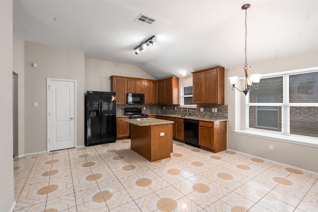 648 Tabasco Trl, Arlington, TX 76002 - kitchen with black appliances, backsplash, vaulted ceiling, a chandelier, and brown cabinets