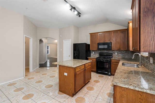 648 Tabasco Trl, Arlington, TX 76002 - kitchen featuring black appliances, a sink, arched walkways, decorative backsplash, and a center island