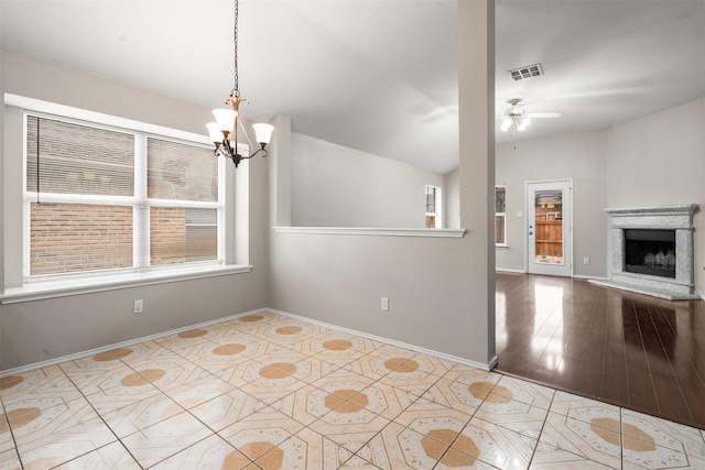 648 Tabasco Trl, Arlington, TX 76002 - unfurnished dining area with a chandelier, ceiling fan, baseboards, a fireplace with raised hearth, and lofted ceiling