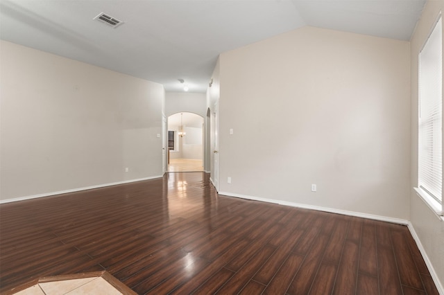 648 Tabasco Trl, Arlington, TX 76002 - empty room with arched walkways, dark wood-style floors, baseboards, and lofted ceiling