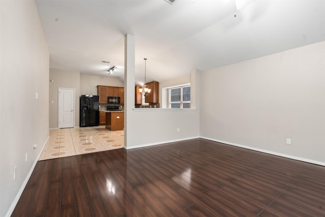 648 Tabasco Trl, Arlington, TX 76002 - unfurnished living room with a chandelier, wood finished floors, vaulted ceiling, and baseboards