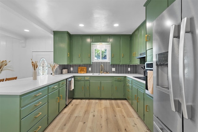 4100 N 30th St, Waco, TX 76708 - kitchen with stainless steel appliances, a peninsula, light wood-type flooring, light countertops, and recessed lighting