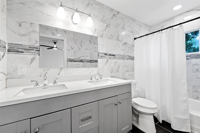 4100 N 30th St, Waco, TX 76708 - bathroom featuring tile walls, double vanity, toilet, shower / tub combo with curtain, and ceiling fan
