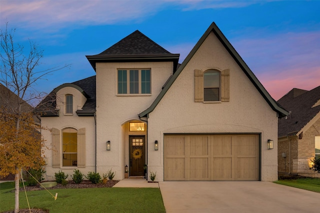 12104 Fairway Meadows Dr, Fort Worth, TX 76179 - french provincial home with a garage, brick siding, concrete driveway, roof with shingles, and a yard